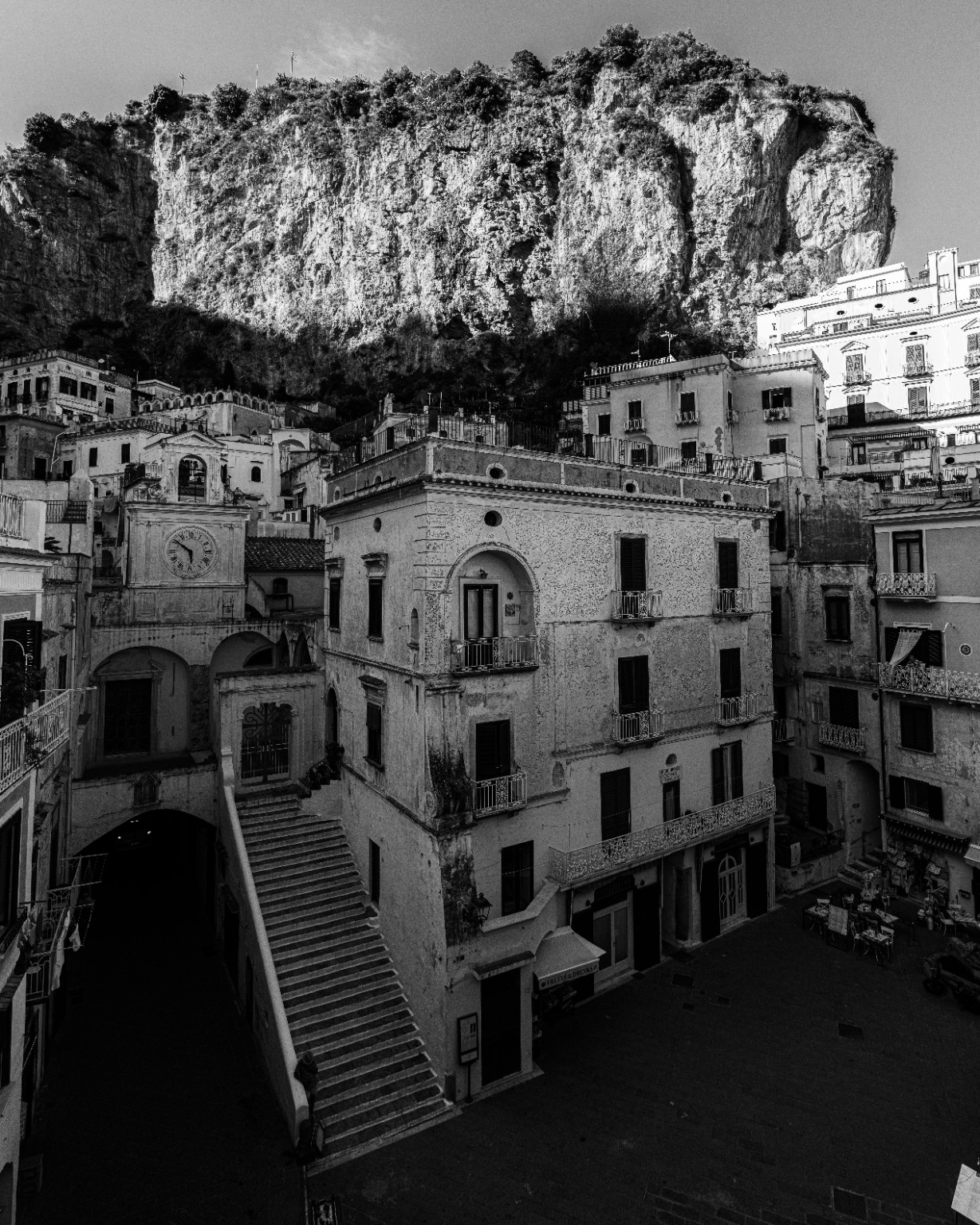 Stairways and clustered facades surround the church of San Salvatore de’ Birecto beneath Atrani’s steep rock walls. Atrani, Amalfi Coast, Italy.